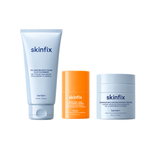 Skinfix Balancing Soft-Foam Clay Cleanser (148 mL | 5 fl.oz.), Brighten + Firm 15% Vitamin C Serum (30 mL | 1 fl. oz.), and Barrier Balancing Water Cream (50 mL | 1.7oz), on a transparent background.